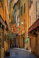 Obraz premium Colorful traditional houses line a narrow street in the Old Town of Nice, France