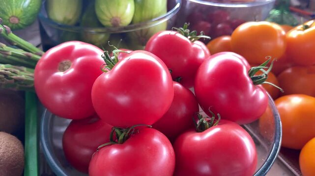 at the market Various vegetables pink and yellow tomatoes kiwi asparagus zucchini many different vegetables
