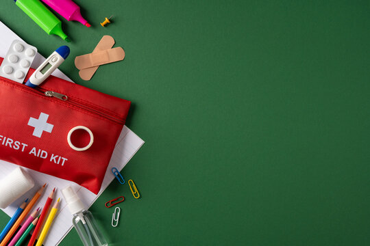 First aid kit and school health supplies on green background for student safety and emergency care