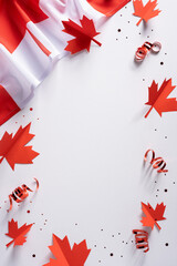 Obraz premium Canadian flag and red maple leaf confetti for Canada Independence Day vertical celebration with ribbon accents