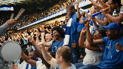 Diverse blue team football supporters chanting in packed stadium stands during live soccer match, fan scarves and excited crowd atmosphere, Father, mother and son sharing family fun with laughter. © DC Studio