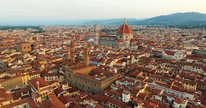 Florence aerial cityscape Palazzo Vecchio tower center Tuscany Italy terracotta rooftops drone dusk Renaissance urban panorama travel landmark slow motion Firenze historic wide overview tourism