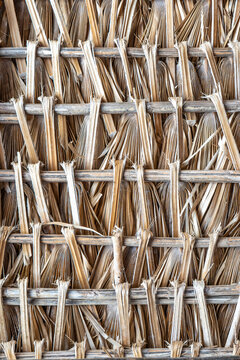 Traditional woven palm leaf wall texture background