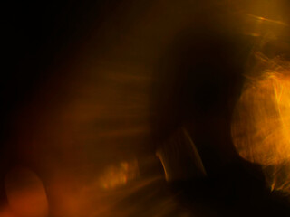 Obraz premium Abstract bokeh lights in warm yellow and cool blue tones. Blurred background creates dreamy, atmospheric mood. Perfect for digital backgrounds, creative projects, or cinematic visuals