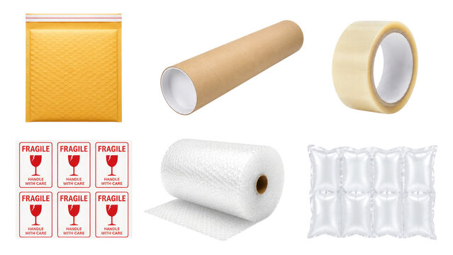 Assortment of shipping and packing supplies including padded mailer, mailing tube, packing tape, fragile labels, bubble wrap roll and air cushion packaging on transparent background