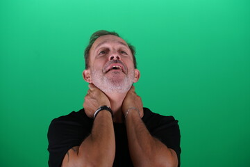 Fototapeta premium Real people. Man at his 50s, Close up shot, isolated on green screen in various poses and facial expressions. Studio capture with clean chroma key background, ideal for compositing