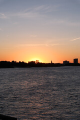 Obraz premium Sunset colors illuminate the sky above a calm river