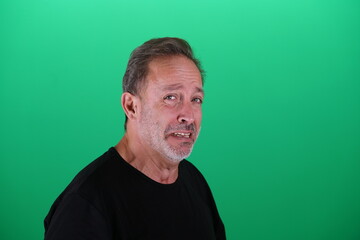 Obraz premium Real people. Man at his 50s, Close up shot, isolated on green screen in various poses and facial expressions. Studio capture with clean chroma key background, ideal for compositing