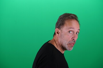 Obraz premium Real people. Man at his 50s, Close up shot, isolated on green screen in various poses and facial expressions. Studio capture with clean chroma key background, ideal for compositing