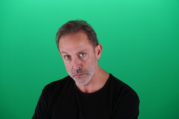 Obraz premium Real people. Man at his 50s, Close up shot, isolated on green screen in various poses and facial expressions. Studio capture with clean chroma key background, ideal for compositing