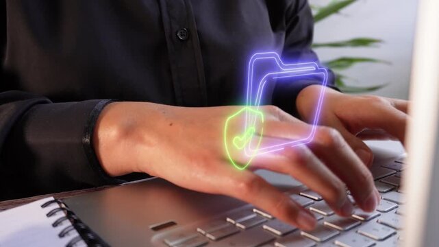 Document verification and security. Close-up of female hands typing on a laptop with a virtual folder icon and a shield containing a checkmark.
