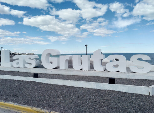 Las Grutas sign in front of the sea in Rio Negro Argentina