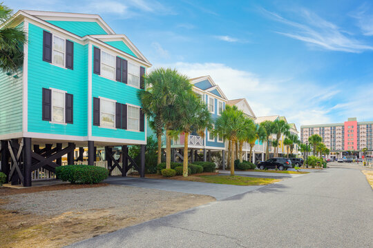Colorful seaside homes raised on stilts to resist flooding along the Grand Strand Atlantic coastline at the oceanfront resort town of Surfside Beach, South Carolina, near Myrtle Beach.