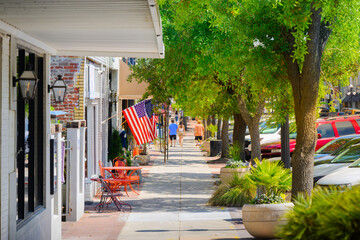 Pedestrians enjoy a sunny day at Harborwalk on Front Street in the early American city of...