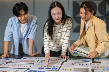 Fototapeta premium Market research, Asian business team analyzing data charts on table, consumer insight, data analysis, marketing strategy, teamwork, problem solving, business development and corporate collaboration