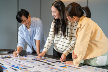 Fototapeta premium Consumer insight, Asian business team analyzing data charts on table, Market research, data analysis, marketing strategy, teamwork, problem solving, business development and corporate collaboration