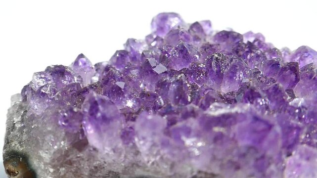 Gemstone Amethyst closeup.amethyst geode with sparkling purple crystals.Radiant texture of agate stone. The luster and sparkle of the agate stone. Purple crystals. 4k footage