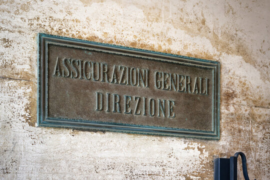 Venice, Italy June 03 2026: An antique bronze plaque reading "Assicurazioni Generali Direzione" on a weathered stone facade at St. Mark's Square in Venice, Italy