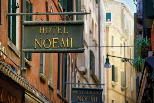 Venice, Italy June 03 2026: An antique wrought iron sign of "Hotel Noemi" featuring golden lettering in a picturesque narrow alley in Venice, Italy