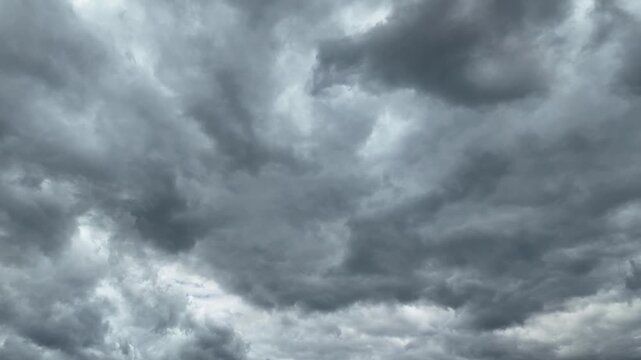 Black and gray clouds cover the sky. Clouds are approaching before a storm and rain with a thunderstorm