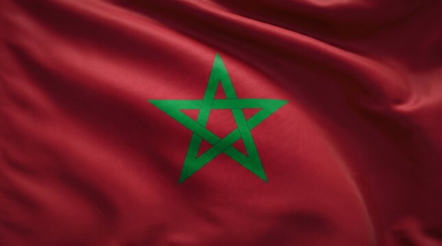 Waving Moroccan flag with green pentagram star emblem on red fabric background