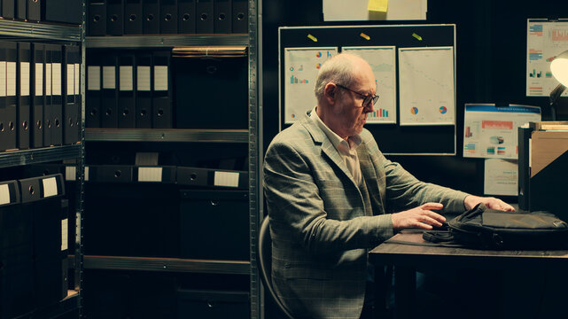 Private inspector opening laptop to cross examine forensic evidence, browsing through classified documents in police archive room, consults media archives for additional information.