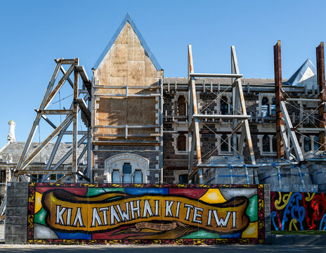 Māori mural 'Kia Atawhai Ki Te Iwi &mdash; Care for the People' lines hoarding surrounding the earthquake-damaged Canterbury Provincial Council Buildings, Christchurch, New Zealand. Oct. 2025