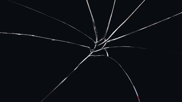 Cracked glass fracture effect on black background. footage of broken glass, crack screen glass.
cracks glass fracture effect texture isolated abstract black background. transparent 4K video.