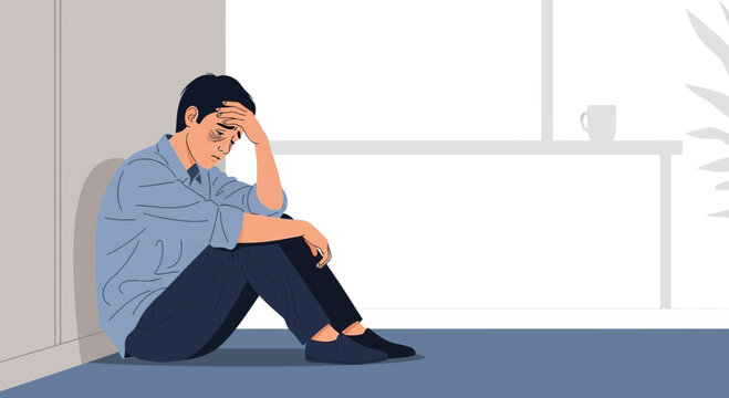 Sad man sitting on floor, holding head, feeling depressed and alone