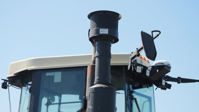 Close up of precision farming equipment mounted on agricultural tractor. GPS guidance and smart farming technology used for modern field operations.