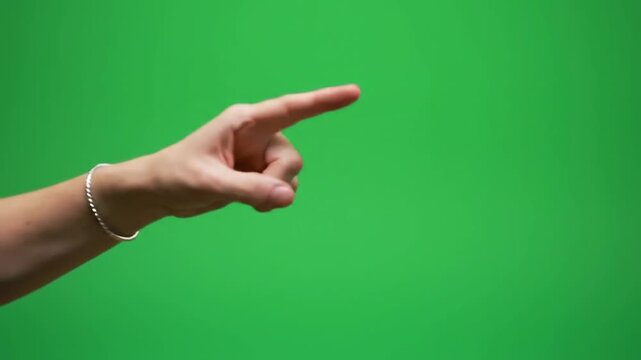Human hand pointing towards right on green screen background.
