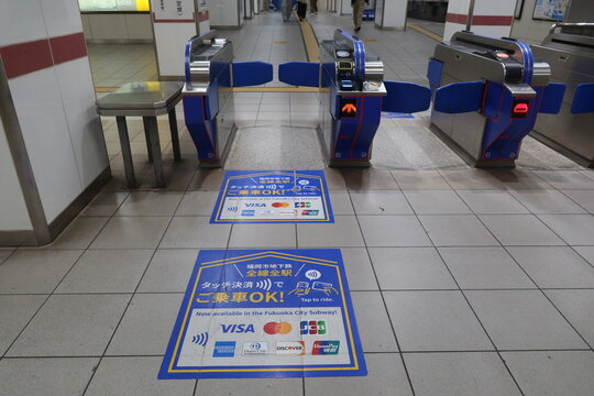 Contactless Credit Card Payment Information Sign Near Ticket Gates at Fukuoka Subway Station, Japan - May 11, 2026