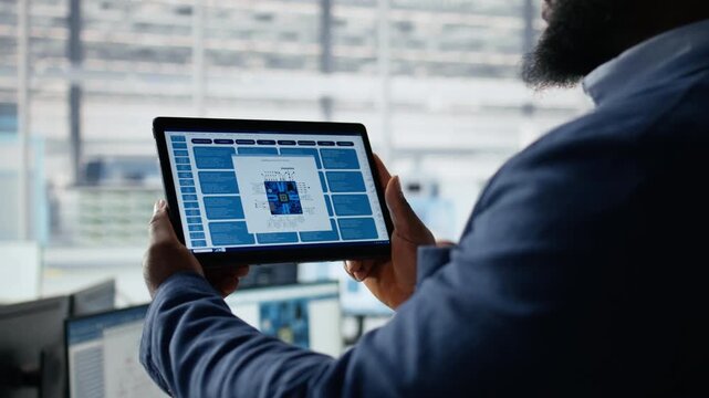 Examining microchip circuit layouts, tablet close up and engineer in factory office.