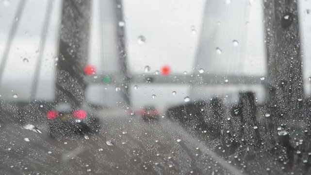 Rain Droplets Moving Upward On Car Windshield While Driving, Reverse Flow Rain Drops On Vehicle Glass In Motion, Close Up Rainwater Sliding Against Gravity On Car Window
