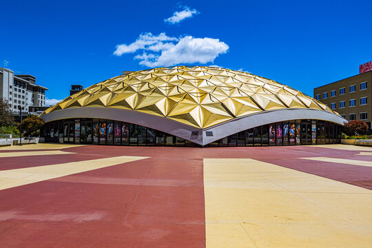 A clear daytime shot of the iconic golden geodesic dome of the Pioneer Center for the Performing Arts in downtown Reno, Nevada.