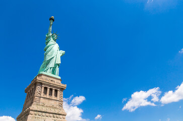 Fototapeta premium Statue of liberty in New York City, USA with blue sky background