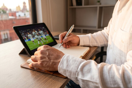 Close Up of Executive Hand in Guayabera Gripping Stylus During Soccer Match.