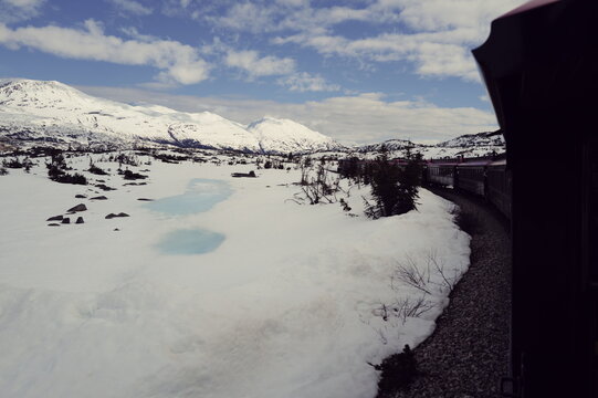 old-fashioned railroad line passing through the Yukon territories in the sping time from Alaska to Canada