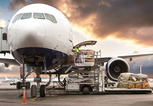 loading cargo into the airplane before departure with nice sky