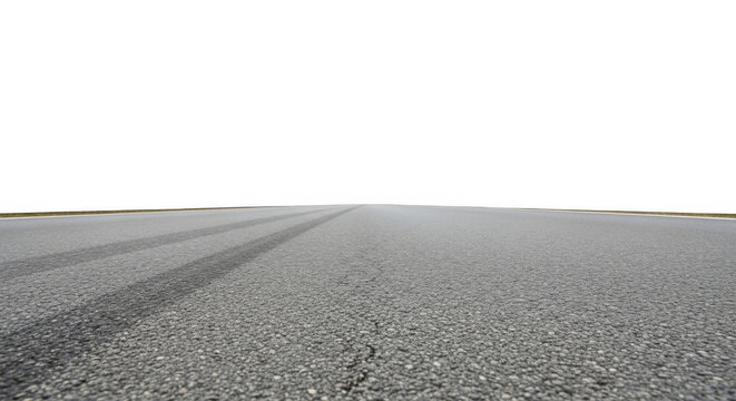 Low angle view of a gray asphalt road surface with dark tire skid marks stretching into the distance against a solid black sky
