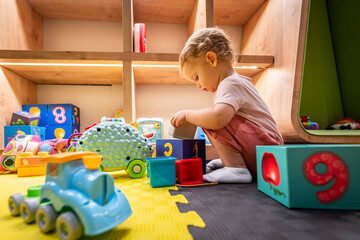 Child discovering colorful blocks and playful toys in a bright and inviting play space
