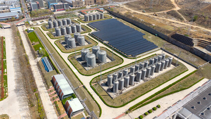 Aerial View of Industrial Tank Farm and Solar Panel Array © Zhaorui