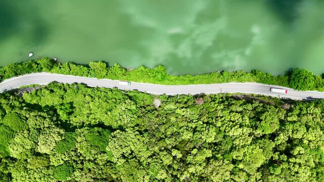 Aerial view of river side road and green mountain in japan, Beautiful landscape and sun light reflection in water.