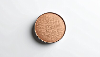 Fototapeta premium Round brown powder compact with subtle texture on white background, beauty product, makeup item