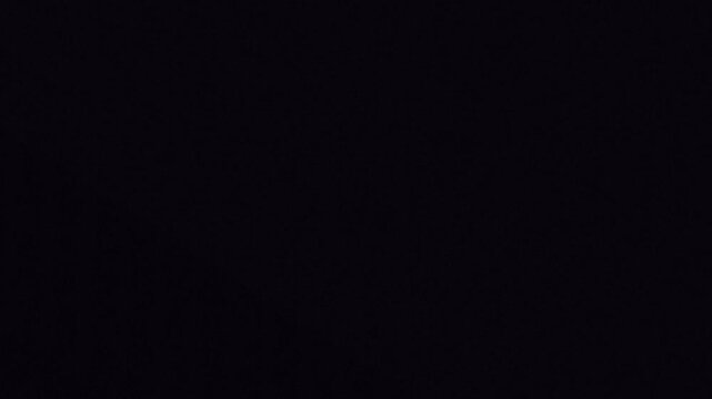 Purple glowing DNA helix strand structure on dark background