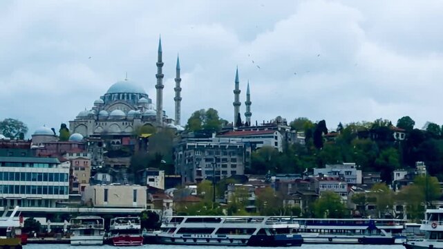 Scenic view of historic Suleymaniye Mosque and Eminonu square background look from Bosphorus sea water with passenger ferry boat ships in Istanbul Turkey. Traditional Turkish culture tourism landmark.