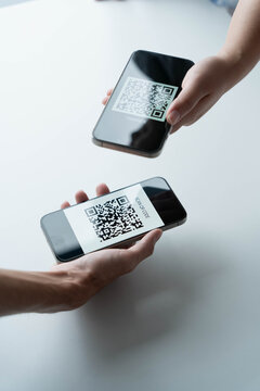 Man using smartphone scanning QR code technology