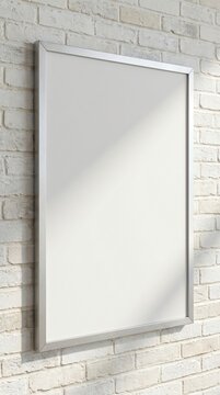 Blank vertical silver poster frame mockup hanging on a white brick wall.