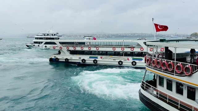 Turkish flag waving on passenger ferry ship boat deck with lifebuoys sailing fast on Bosphorus sea strait water near Istanbul Golden Horn bay. Maritime transport vessel cruise with flying seagulls.