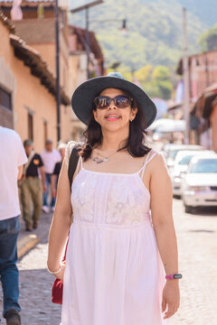 Medium Portrait of Smiling Woman Walking in a Mexican town Malinalco Street